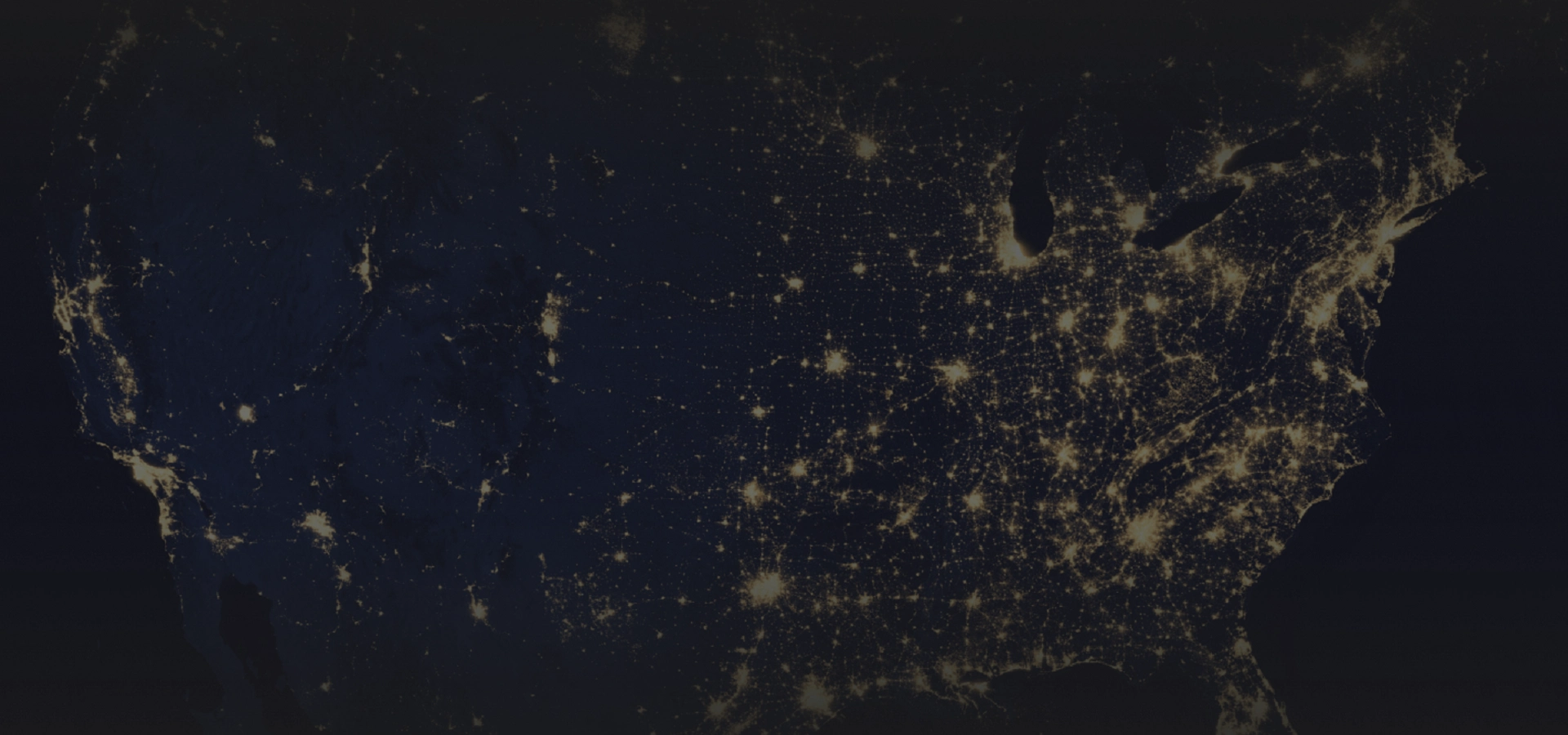 Red42_Bloque_HeroHomeSingle Night-time satellite view of the United States, showing glowing city lights across the map from space orbits above Earth.